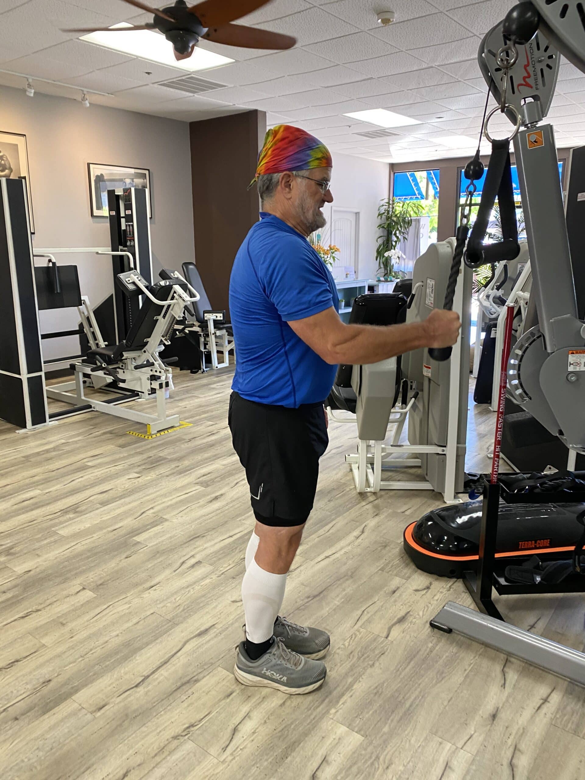 A man standing in front of a gym machine.