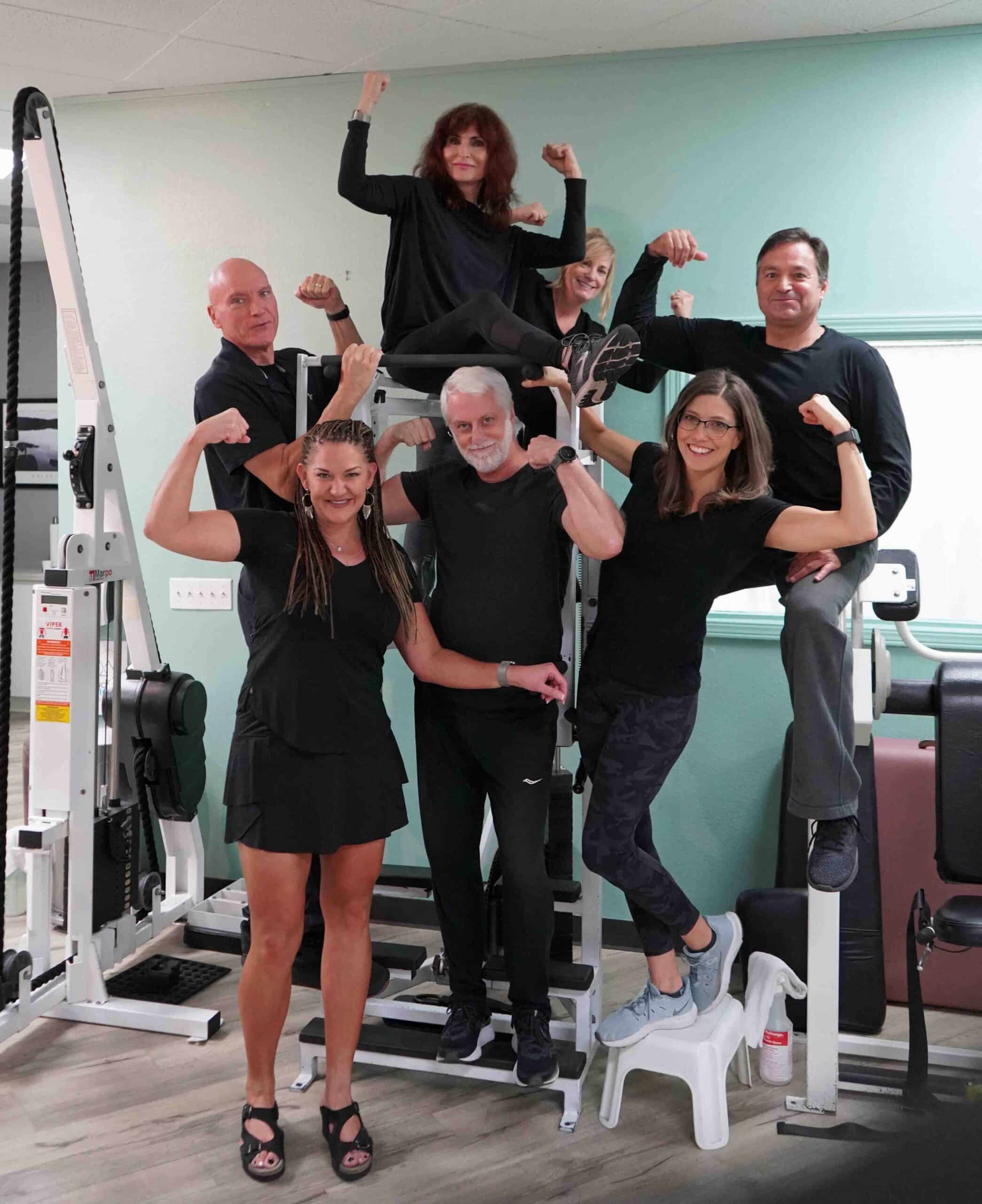 A group of people striking a pose for a photo in a gym's homepage.