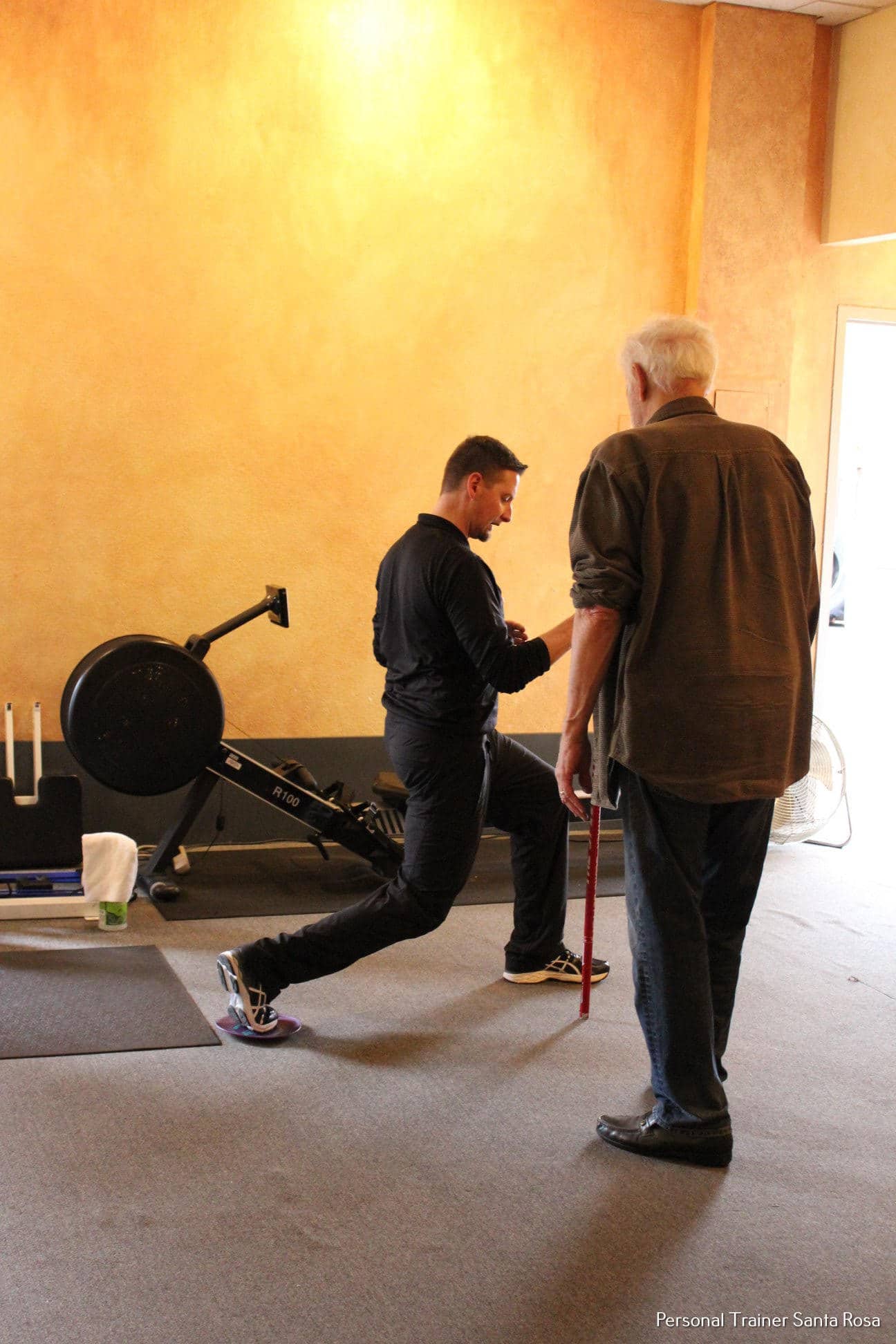 A man and a woman in a gym.